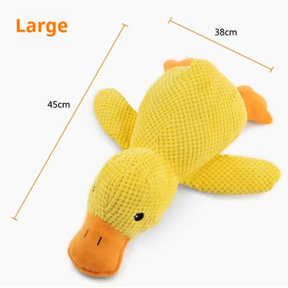 Dog sleeping with a dog hug duck toys