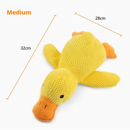 Dog sleeping with a dog hug duck toys