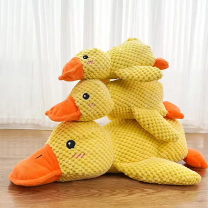 Dog sleeping with a dog hug duck toys